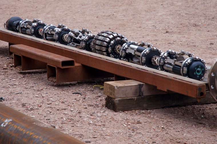 Multi-purpose crawler tool on pallet.