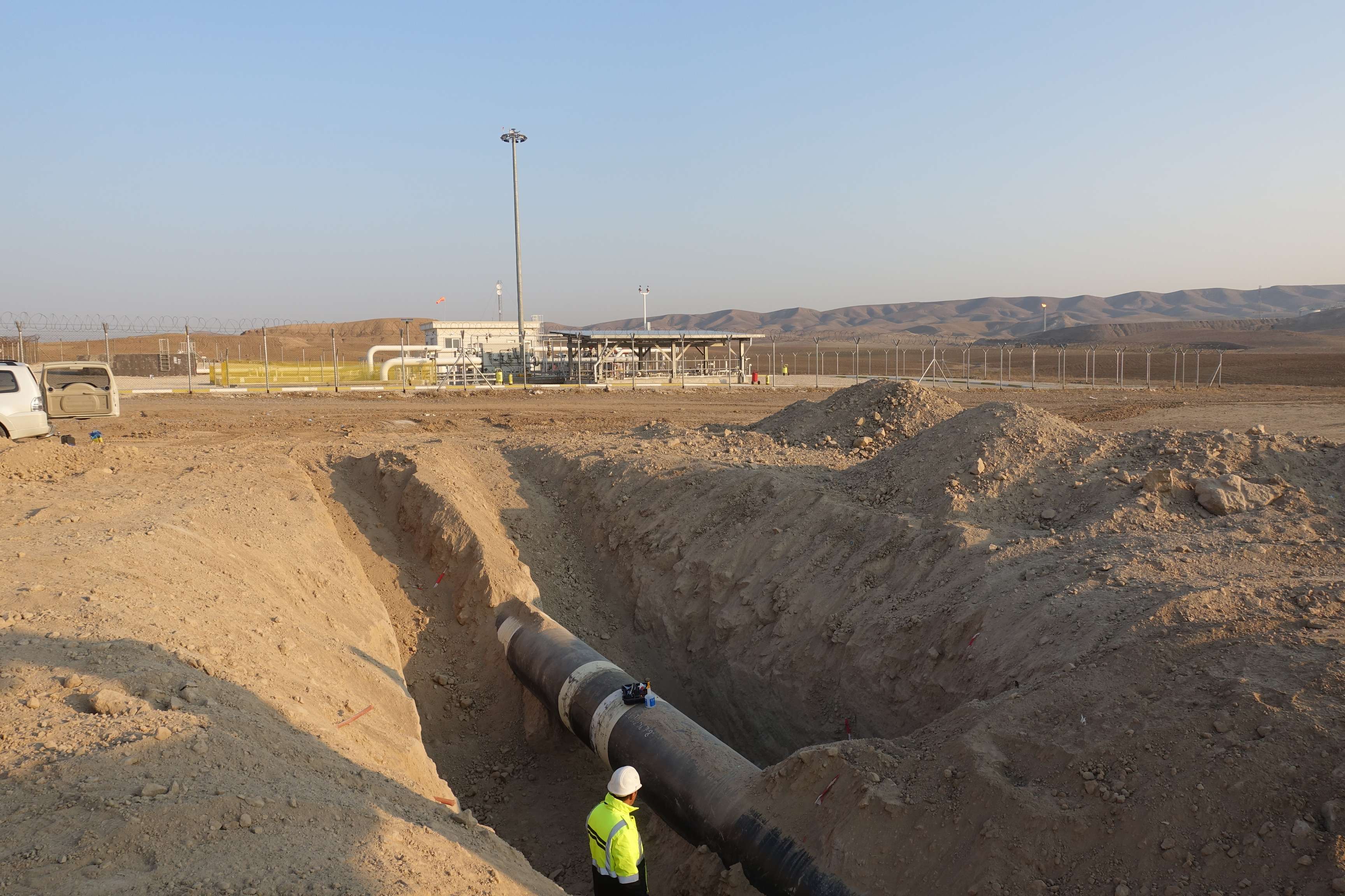 ROSEN field verification technicians standing in front of an excavated pipeline.