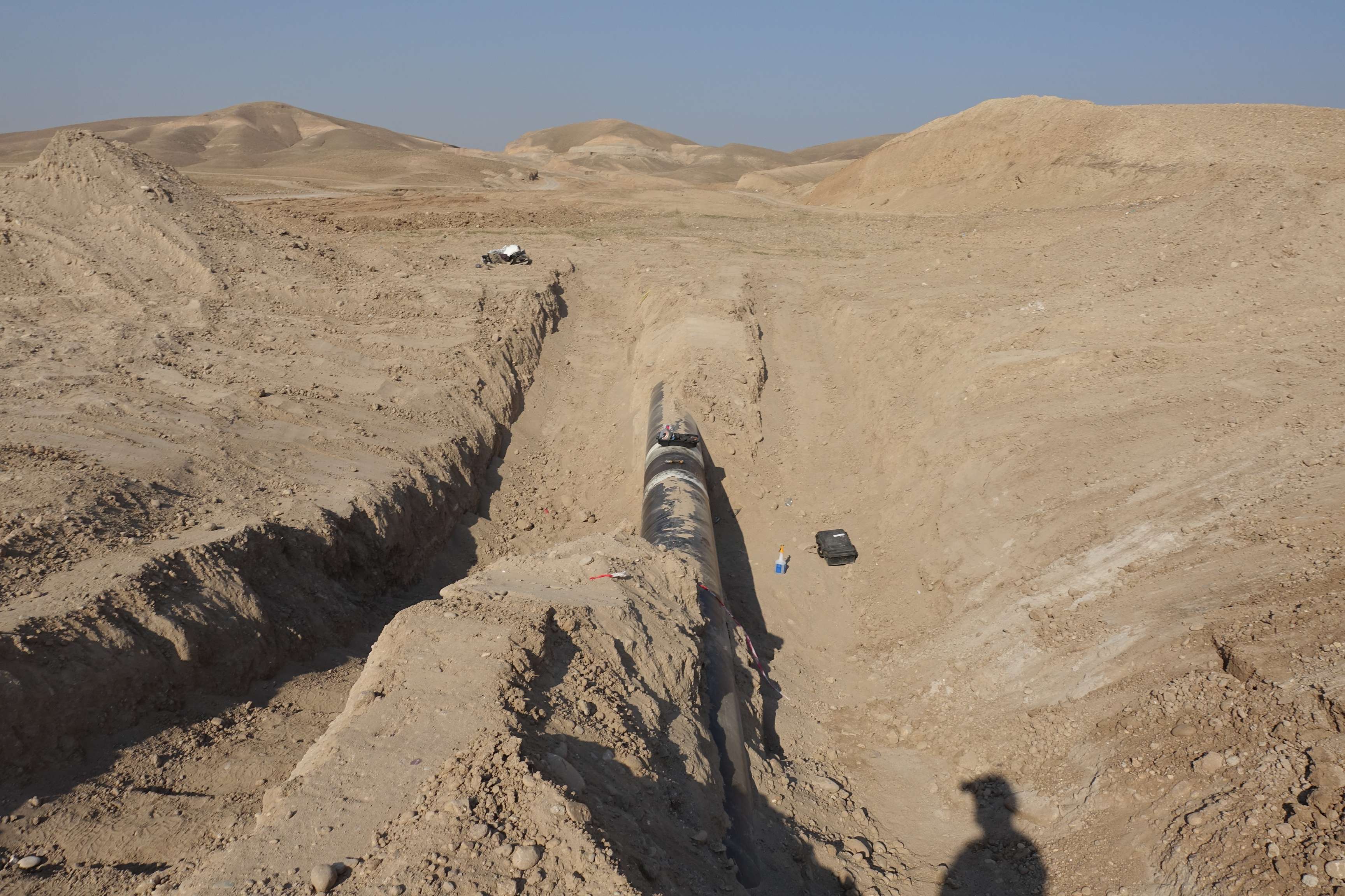 Excavated pipeline in a desert.